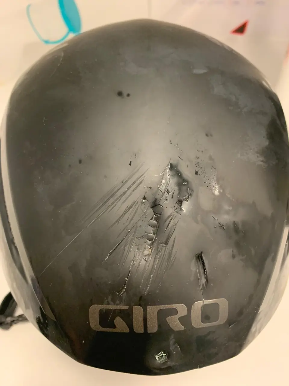 A cracked and scratched bike helmet after the crash